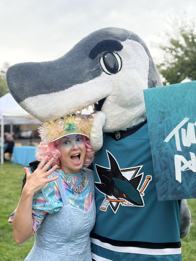 Miss Molly posing with the San Jose Sharks mascot