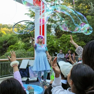 Miss Molly making bubbles for guests at Gilroy Gardens