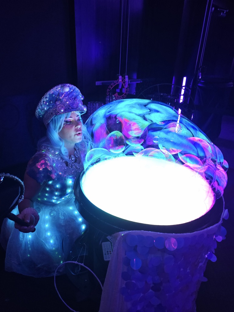 Miss Molly making colorful bubbles on her LED bubble table