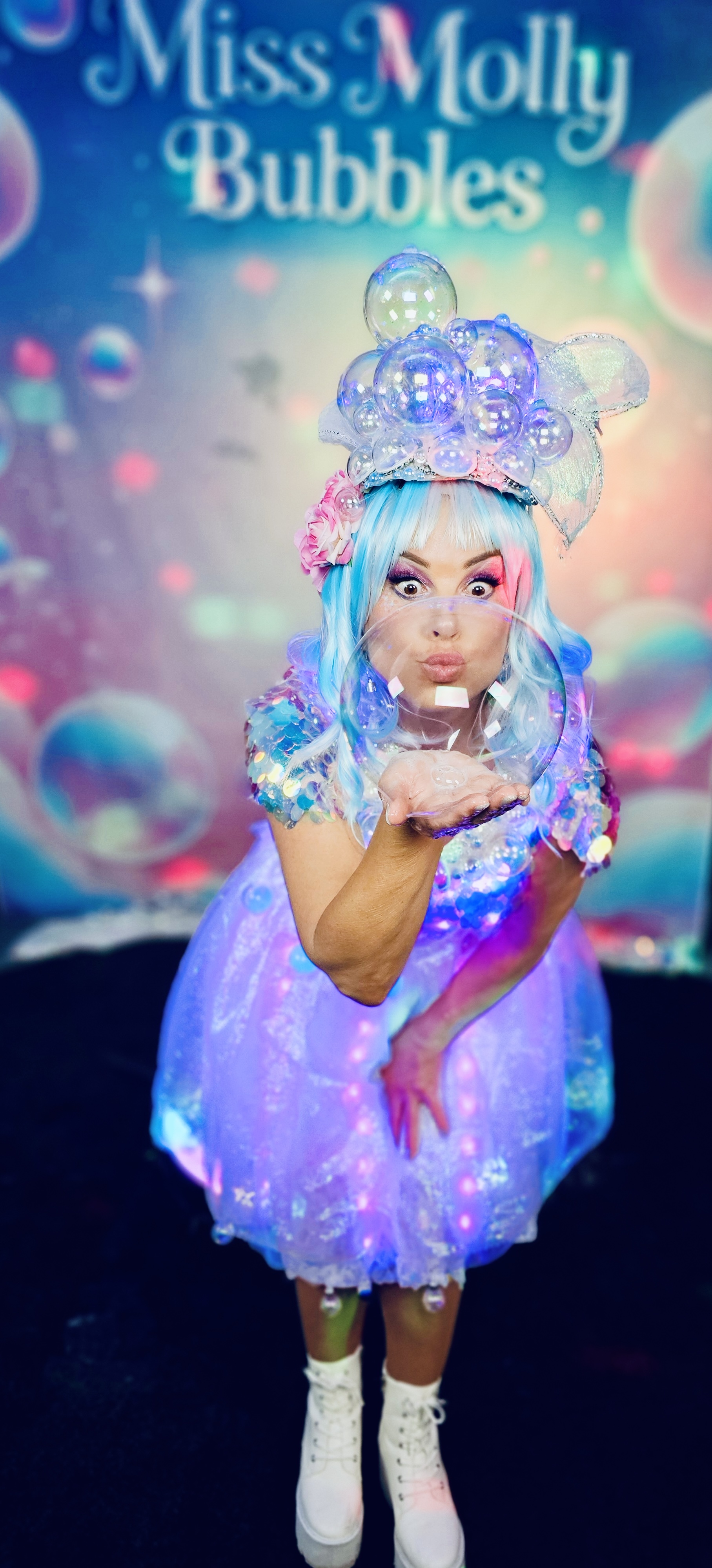Miss Molly holding a bubble in her illuminated LED dress