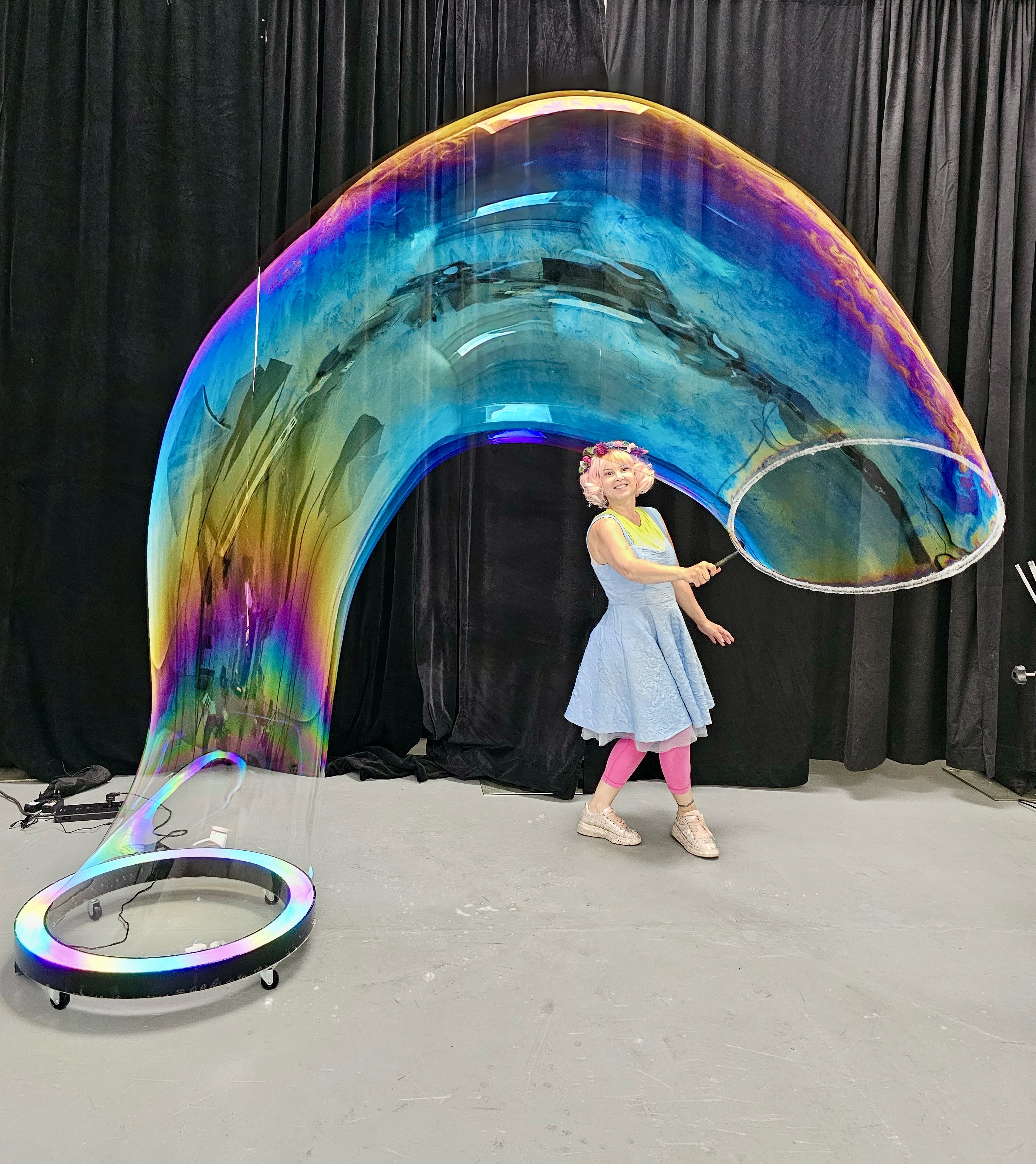Miss Molly making a giant rainbow bubble