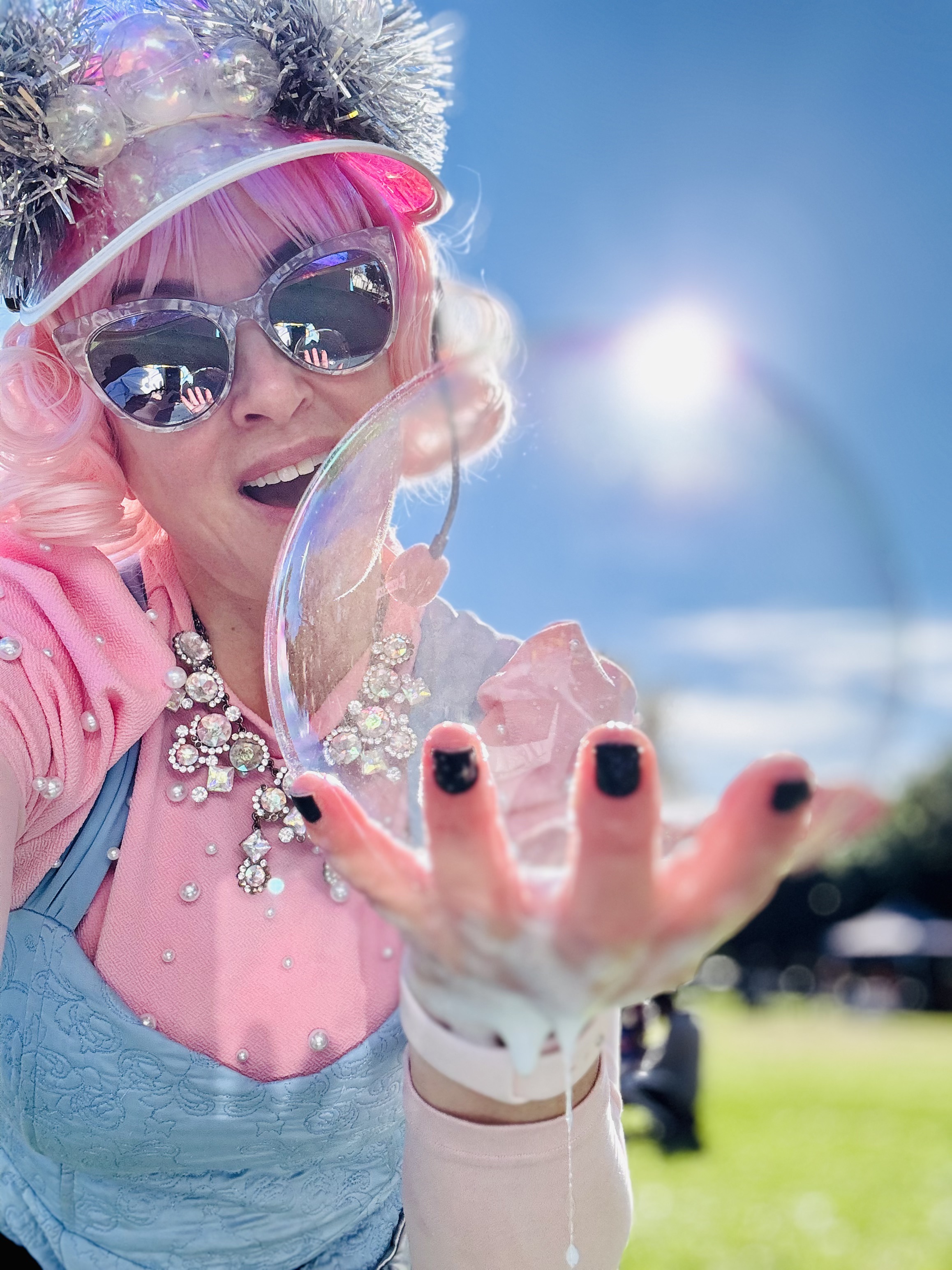 Miss Molly wearing sunglasses and holding a bubble